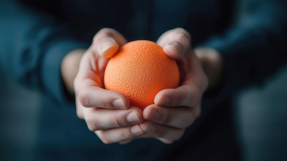 closeup-hands-holding-vibrant-or